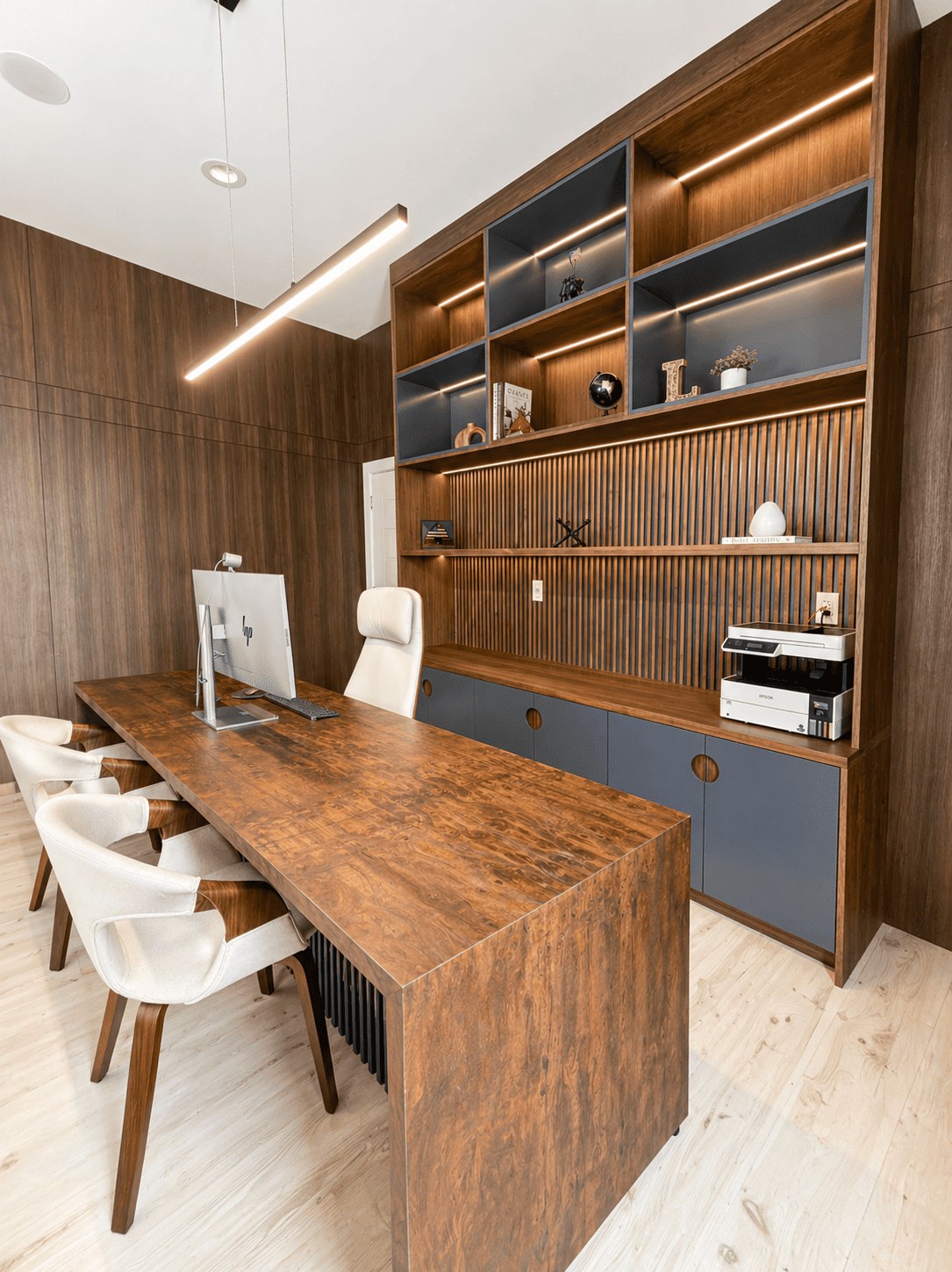 Bedford Residence walnut office with lit shelving and a live-edge desk