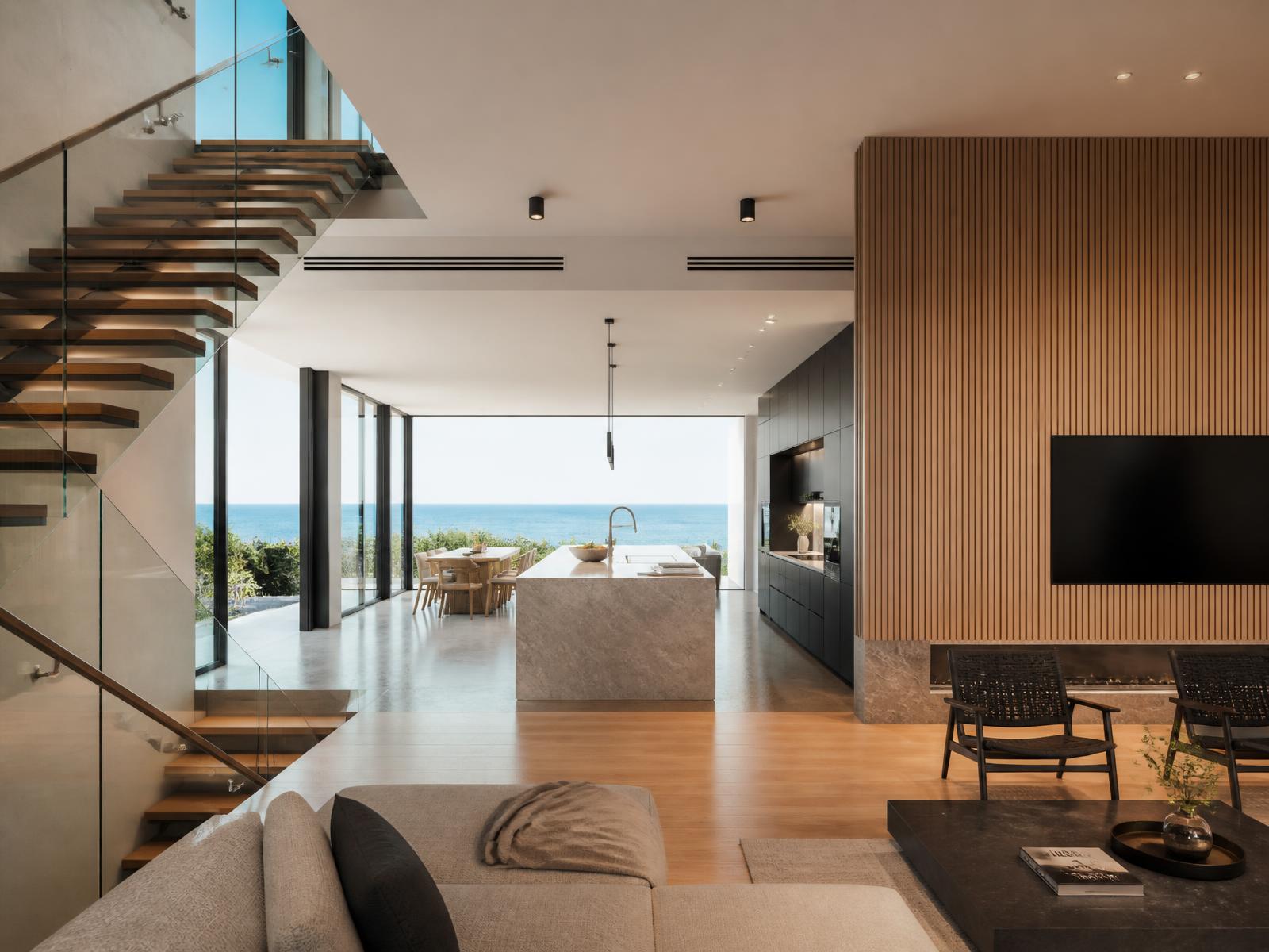 Contemporary oceanfront interior with slatted oak wall and stone island